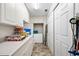 White cabinets and a small refrigerator in this storage area at 136 Creek Se Dr, Port Charlotte, FL 33952