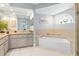 Elegant bathroom with soaking tub, shower, and granite vanity at 1460 Raven Ct, Punta Gorda, FL 33950