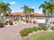 Beautiful home exterior with a brick driveway and lush landscaping at 1460 Raven Ct, Punta Gorda, FL 33950