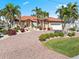 Beautiful waterfront home with a tile roof, lush landscaping, and a brick driveway at 1460 Raven Ct, Punta Gorda, FL 33950