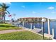 Beautiful canal front view with private dock and lush landscaping at 1460 Raven Ct, Punta Gorda, FL 33950