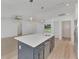 Modern kitchen with island, stainless steel appliances, and white cabinets at 1543 Gorham St, North Port, FL 34288