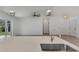 Kitchen island with sink, stainless steel faucet, and pendant lighting at 1543 Gorham St, North Port, FL 34288