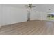 Spacious living area with light wood flooring and ceiling fan at 1543 Gorham St, North Port, FL 34288