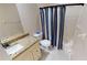 Clean bathroom with granite countertop, shower/tub combo, and striped shower curtain at 16129 Coruna Ct, Punta Gorda, FL 33955