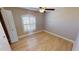 Bright bedroom featuring wood-look floors and a large window with shutters at 16129 Coruna Ct, Punta Gorda, FL 33955