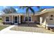 Tan house with gray roof, screened porch, and landscaped yard at 16129 Coruna Ct, Punta Gorda, FL 33955