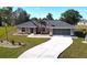 Single story house with driveway and palm trees at 16129 Coruna Ct, Punta Gorda, FL 33955