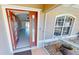 Inviting entryway with an orange door and tiled floor at 16129 Coruna Ct, Punta Gorda, FL 33955