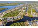 Aerial view showcasing a waterfront community with homes and canals at 17456 Foremost Ln, Port Charlotte, FL 33948