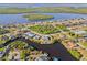 Aerial view of a waterfront home and surrounding neighborhood at 17456 Foremost Ln, Port Charlotte, FL 33948