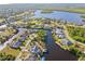 Aerial view highlighting a single-Gathering home on a canal with a backyard at 17456 Foremost Ln, Port Charlotte, FL 33948