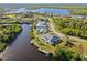 Bird's-eye view showcasing home's waterfront location and private screened pool area at 17456 Foremost Ln, Port Charlotte, FL 33948