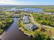 Aerial view of waterfront home with private dock and lush landscaping at 17456 Foremost Ln, Port Charlotte, FL 33948