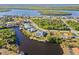 Waterfront property aerial view, showcasing a canal-front home and neighborhood at 17456 Foremost Ln, Port Charlotte, FL 33948