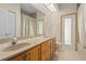 Bathroom with double sinks, a shower, and an exterior door at 17456 Foremost Ln, Port Charlotte, FL 33948