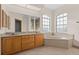 Bathroom with double vanity, soaking tub, and large windows at 17456 Foremost Ln, Port Charlotte, FL 33948