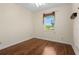 Cozy bedroom featuring wood flooring and a large window at 17456 Foremost Ln, Port Charlotte, FL 33948