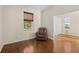 Relaxing bedroom with wood floors, a recliner, and access to another room at 17456 Foremost Ln, Port Charlotte, FL 33948