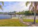 Peaceful waterfront view of the canal with a private dock and picnic table at 17456 Foremost Ln, Port Charlotte, FL 33948