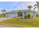 Single-story home with two-car garage and landscaped yard at 17456 Foremost Ln, Port Charlotte, FL 33948