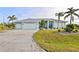 Front view of two-car garage and manicured lawn at 17456 Foremost Ln, Port Charlotte, FL 33948