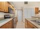 View of kitchen's stainless steel appliances and wood cabinets at 17456 Foremost Ln, Port Charlotte, FL 33948