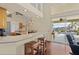 Kitchen with breakfast bar, wood cabinets, and pool view at 17456 Foremost Ln, Port Charlotte, FL 33948