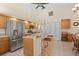 Bright kitchen with stainless steel appliances and an oak wood breakfast bar at 17456 Foremost Ln, Port Charlotte, FL 33948