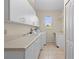 Laundry room with washer, dryer, and cabinets at 17456 Foremost Ln, Port Charlotte, FL 33948
