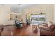Spacious living room with hardwood floors and sliding doors leading to pool and canal views at 17456 Foremost Ln, Port Charlotte, FL 33948