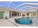 Inviting kidney-shaped pool with a screened enclosure at 17456 Foremost Ln, Port Charlotte, FL 33948