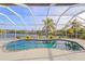 Kidney-shaped pool with a screened enclosure overlooking a tranquil canal at 17456 Foremost Ln, Port Charlotte, FL 33948