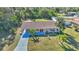Aerial view of single story home with landscaped yard and driveway at 19071 Helena Ave, Port Charlotte, FL 33948