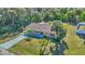 Aerial view of a single-story house with a large front yard and surrounding trees at 19071 Helena Ave, Port Charlotte, FL 33948