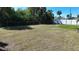 Large grassy backyard with a white fence and bird bath at 19071 Helena Ave, Port Charlotte, FL 33948