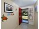 Bright entryway with red door, tiled floors, and decorative wall art at 19071 Helena Ave, Port Charlotte, FL 33948