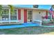 House exterior with red door and landscaping at 19071 Helena Ave, Port Charlotte, FL 33948
