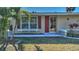 Front entrance with red door and window box at 19071 Helena Ave, Port Charlotte, FL 33948