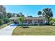 Single-story home with carport and American flag at 19071 Helena Ave, Port Charlotte, FL 33948