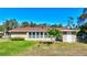 Tan house with red roof, palm trees, and a white shed at 19071 Helena Ave, Port Charlotte, FL 33948