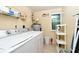 Laundry room with washer, dryer, shelving, and storage at 19071 Helena Ave, Port Charlotte, FL 33948