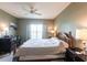 Primary bedroom with large bed, nightstands and ceiling fan at 19375 Water Oak Dr # 203, Port Charlotte, FL 33948