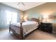 Spacious bedroom with wooden bed frame and ample natural light at 19375 Water Oak Dr # 203, Port Charlotte, FL 33948