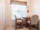 Small breakfast nook with table and chairs near window at 19375 Water Oak Dr # 203, Port Charlotte, FL 33948