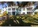 Two-story building with screened balconies and tree shade at 19375 Water Oak Dr # 203, Port Charlotte, FL 33948