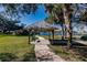 Gazebo with bench overlooking a lake, offering serene views at 19375 Water Oak Dr # 203, Port Charlotte, FL 33948