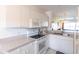 Clean and bright kitchen with white cabinets and appliances at 19375 Water Oak Dr # 203, Port Charlotte, FL 33948