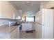 White kitchen cabinets and appliances, including a stove and refrigerator at 19375 Water Oak Dr # 203, Port Charlotte, FL 33948