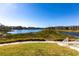 Scenic lake view with grassy areas and a walkway at 19375 Water Oak Dr # 203, Port Charlotte, FL 33948
